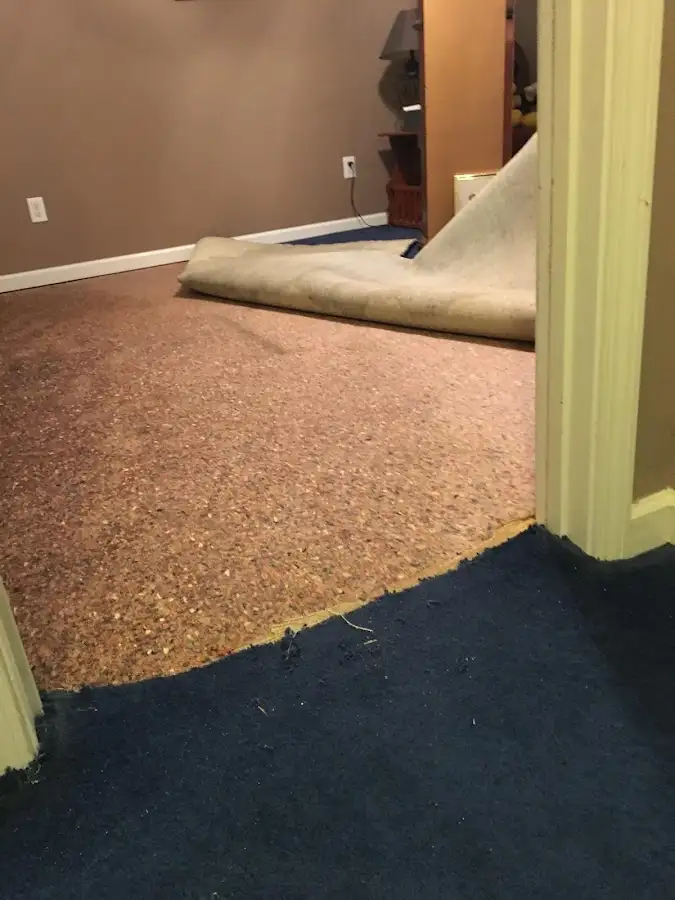 Carpet pad removal revealing water damage during Drying & Dehumidification in Owosso
